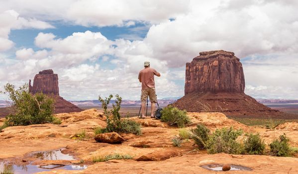 Hiker photographer taking picture of the Monument Valley from view point