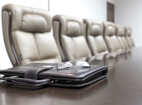 Closeup of on table in empty corporate conference room before business meeting in office