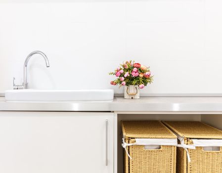 Modern white laundry room with baskets