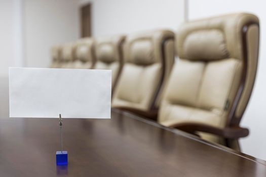 Closeup of on table in empty corporate conference room before business meeting in office