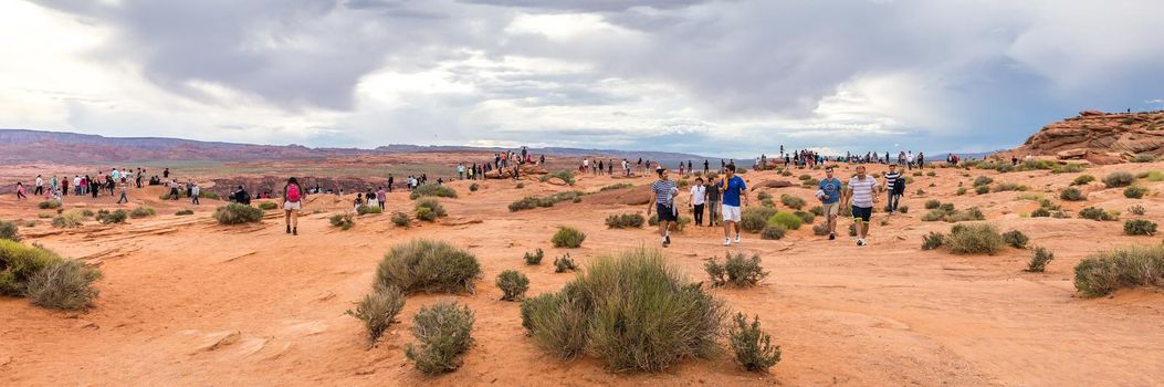 PAGE, ARIZONA - MAY 25: Hikers at Horseshoe Bend on May 25, 2015 in Page AZ,USA. Thousands of people from all over the world visit this unique place every year.