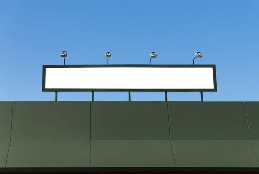 Blank sign with lights on the roof of a building