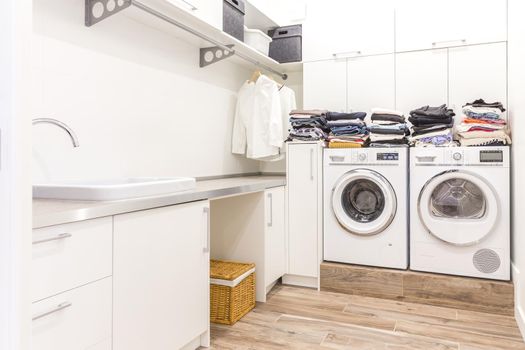 Piles of clean clothes in laundry room