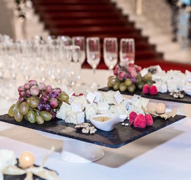 Buffet table with brie cheese and grapes