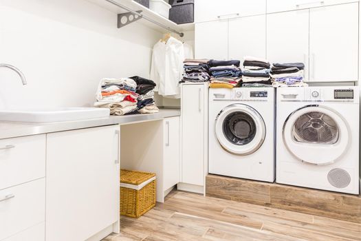 Stacks of clean clothes in utility room