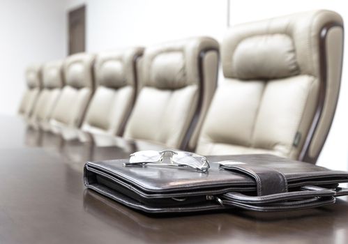 Closeup of on table in empty corporate conference room before business meeting in office