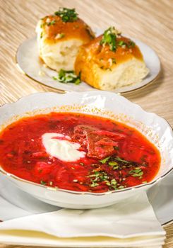 Ukrainian and russian beetroot soup (borscht) with sour cream and garlic