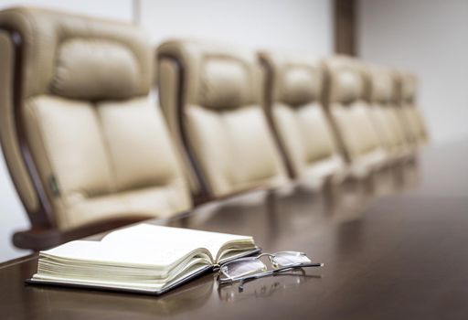 Closeup of on table in empty corporate conference room before business meeting in office