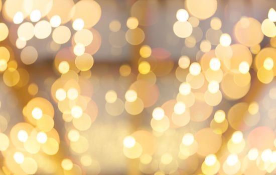 Golden abstract background with bokeh defocused lights