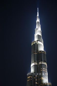 DUBAI, UNITED ARAB EMIRATES – JANUARY 20: Tower Burj Khalifa vanishing in blue sky on January 20, 2014 in Dubai. It is the tallest structure in world since 2010, 829.8 meters and one of the most visited tourist attractions in the world.