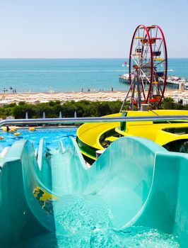 ANTALYA, TURKEY - MAY 11, 2014: Colorful waterpark tubes and Ferris wheel in Delphin Imperial hotel on MAY 11, 2014 in Antalia.