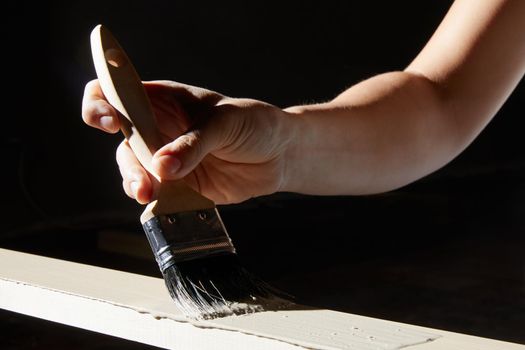 Hand painting surface of natural wood plank into white color