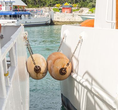 Yachts docked side by side separated by dock bumpers