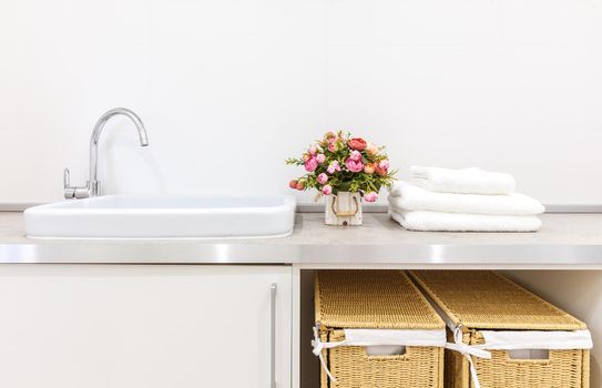 Modern white laundry room with baskets
