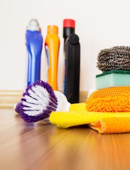 set of cleaning equipment on a wooden floor