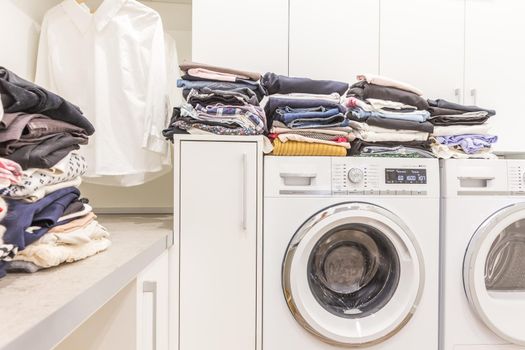 Piles of clean clothes in laundry room