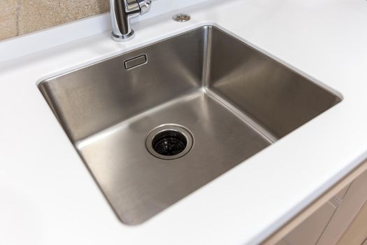 Stainless kitchen sink with food waste disposal