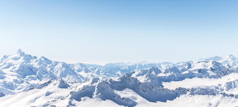 White snowy winter Caucasus mountains at sunny day. Panorama view from ski slope Elbrus, Russia with sky background