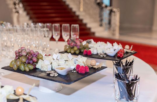Buffet table with brie cheese and grapes