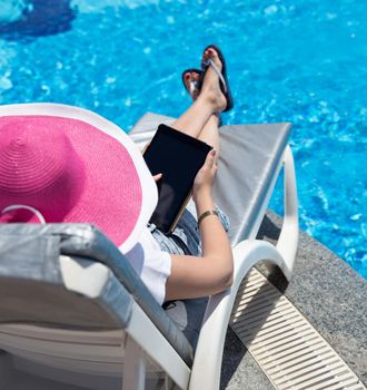 woman on sunbed waering beautiful pink hat