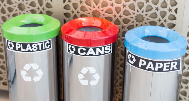 three bins for garbage seperation, plastic, cans, paper