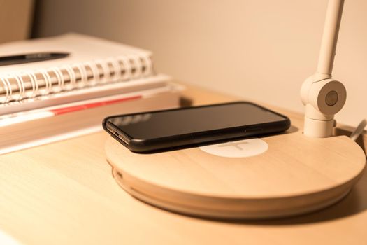 Smartphone in black case charging wireless