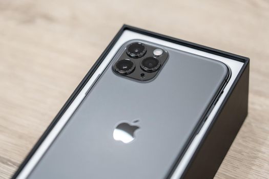 Moscow, Russia - September 24, 2019: new Apple iPhone 11 pro in box on wooden background