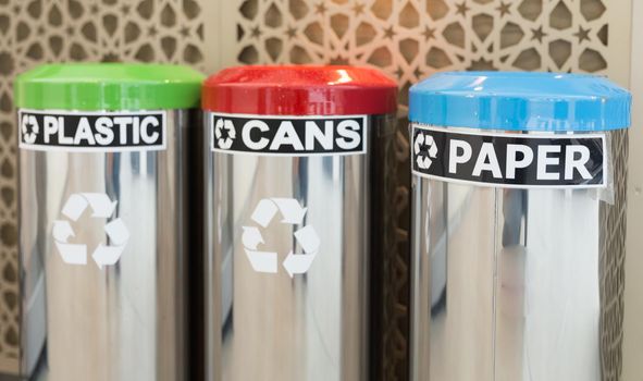 three bins for garbage seperation, plastic, cans, paper