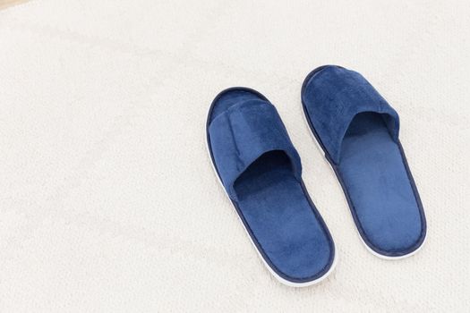 Blue man hotel slippers with copy space