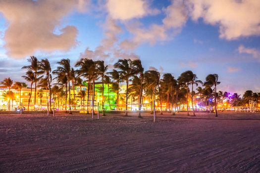 Ocean Drive Miami Beach at sunset. City skyline with palm trees at dusk. Art deco on South beach