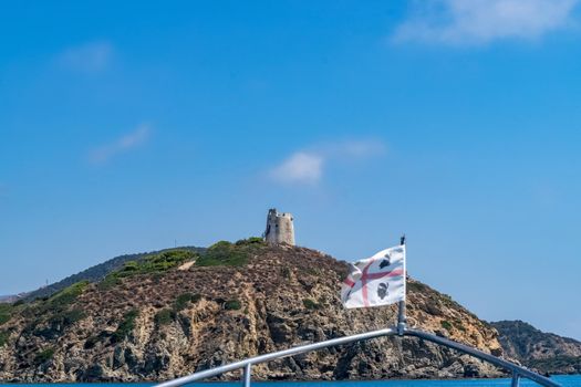 Beautiful view of the southern Sardinian sea from the boat. Note the historic Saracen tower on the rock formations.