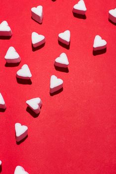 Valentines Day candy hearts marshmallows over red background