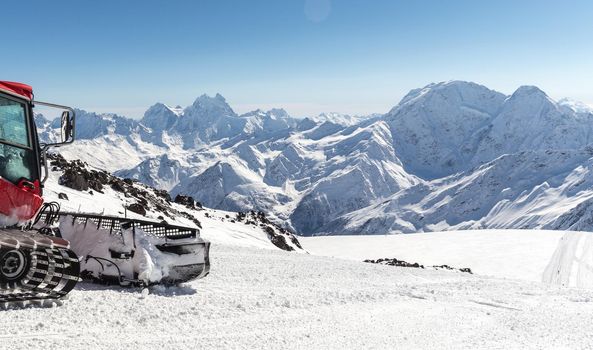 Snowcat on a slope high up in the mountains