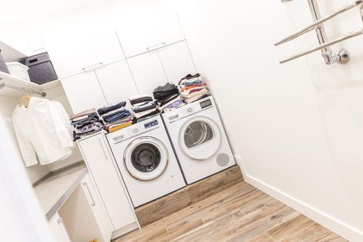 Stacks of clean clothes in utility room
