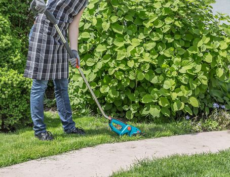 Happy female working in garden in summer