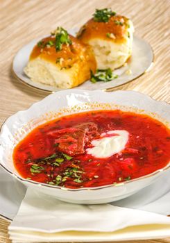 Ukrainian and russian beetroot soup (borscht) with sour cream and garlic