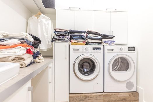 Stacks of clean clothes in utility room