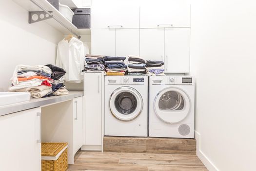 Piles of clean clothes in laundry room