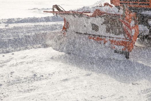 Snowplow removing snow from city road