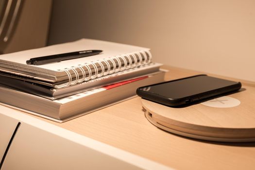 Smartphone in black case charging wireless
