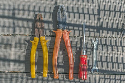 Set of old simple tools pliers, screwdriver and wrench for housework