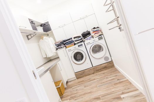 Stacks of clean clothes in utility room