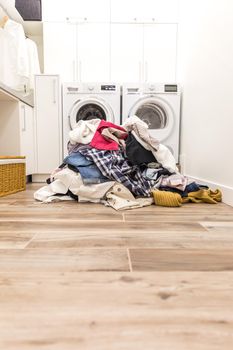 Pile of dirty clothes in laundry room with copy space