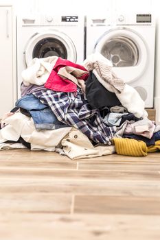 Pile of dirty clothes in laundry room with copy space