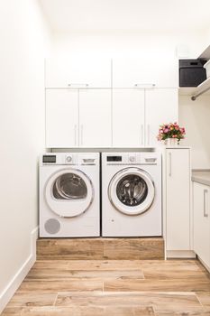 Laundry room in white modern style with wasing and drying machine