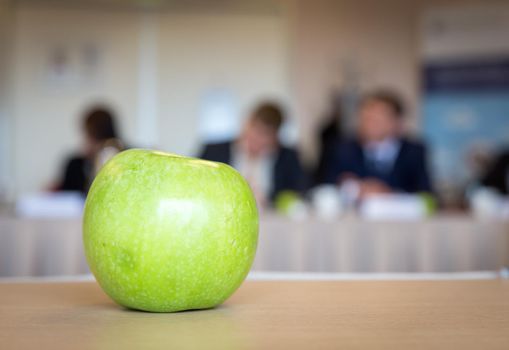 Green apple on a table during a business meeting