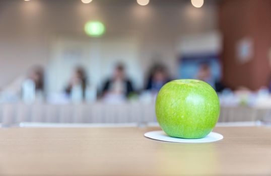 Green apple on a table during a business meeting