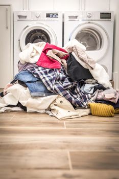 Pile of dirty clothes in laundry room with copy space