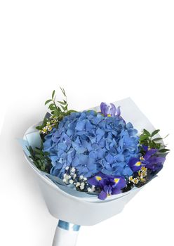 On a white background, a beautifully packaged bouquet of fresh flowers of blue hydrangea and irises. Front view, vertical orientation, copy space