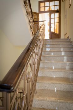 old-styled marble staircase with handrails in a hotel